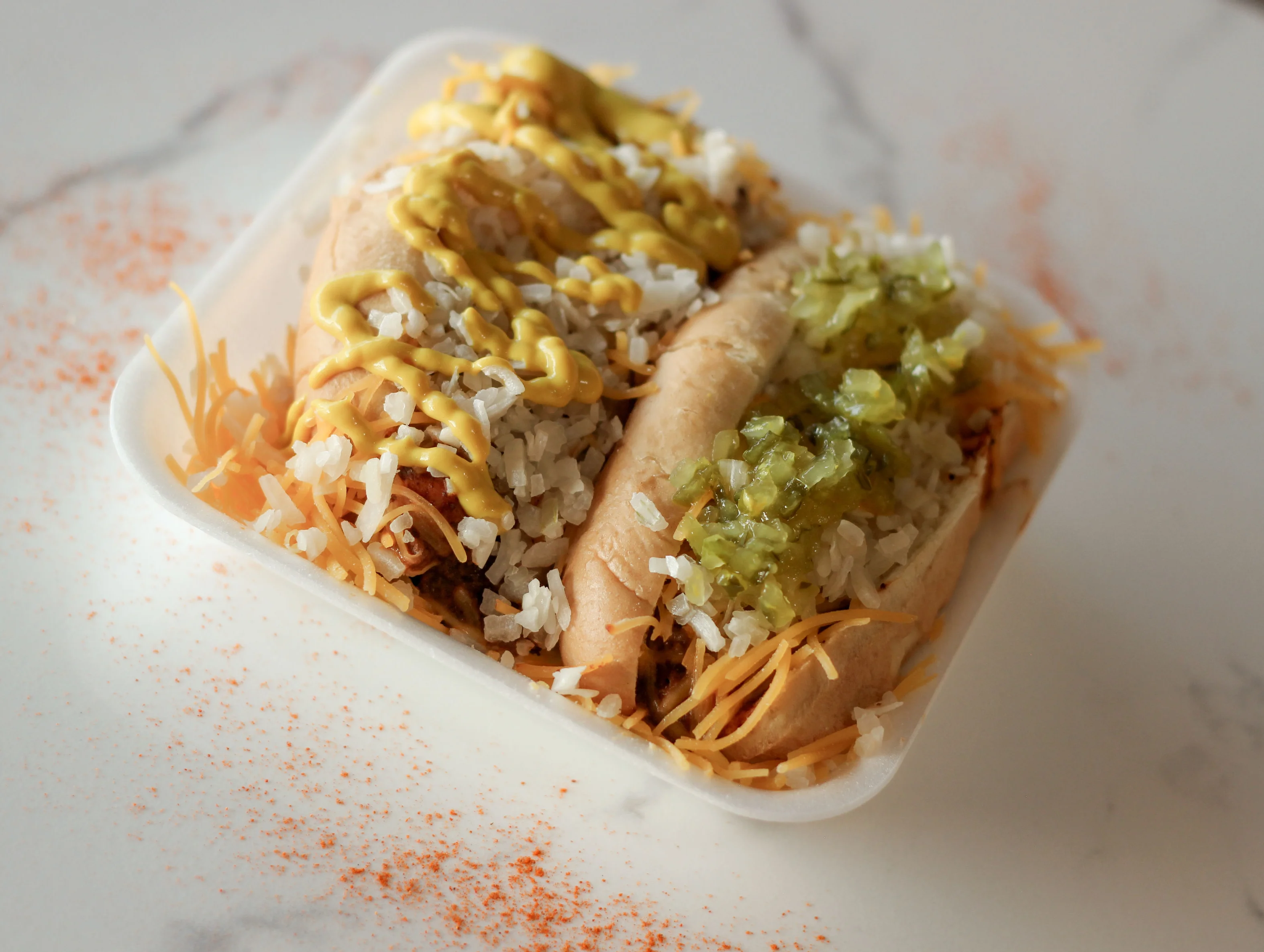 Delicious American chili cheese dogs with rice and toppings