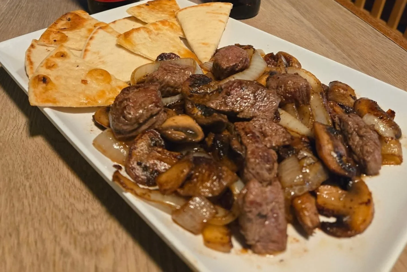 Sizzling beef fajitas with grilled onions and tortillas