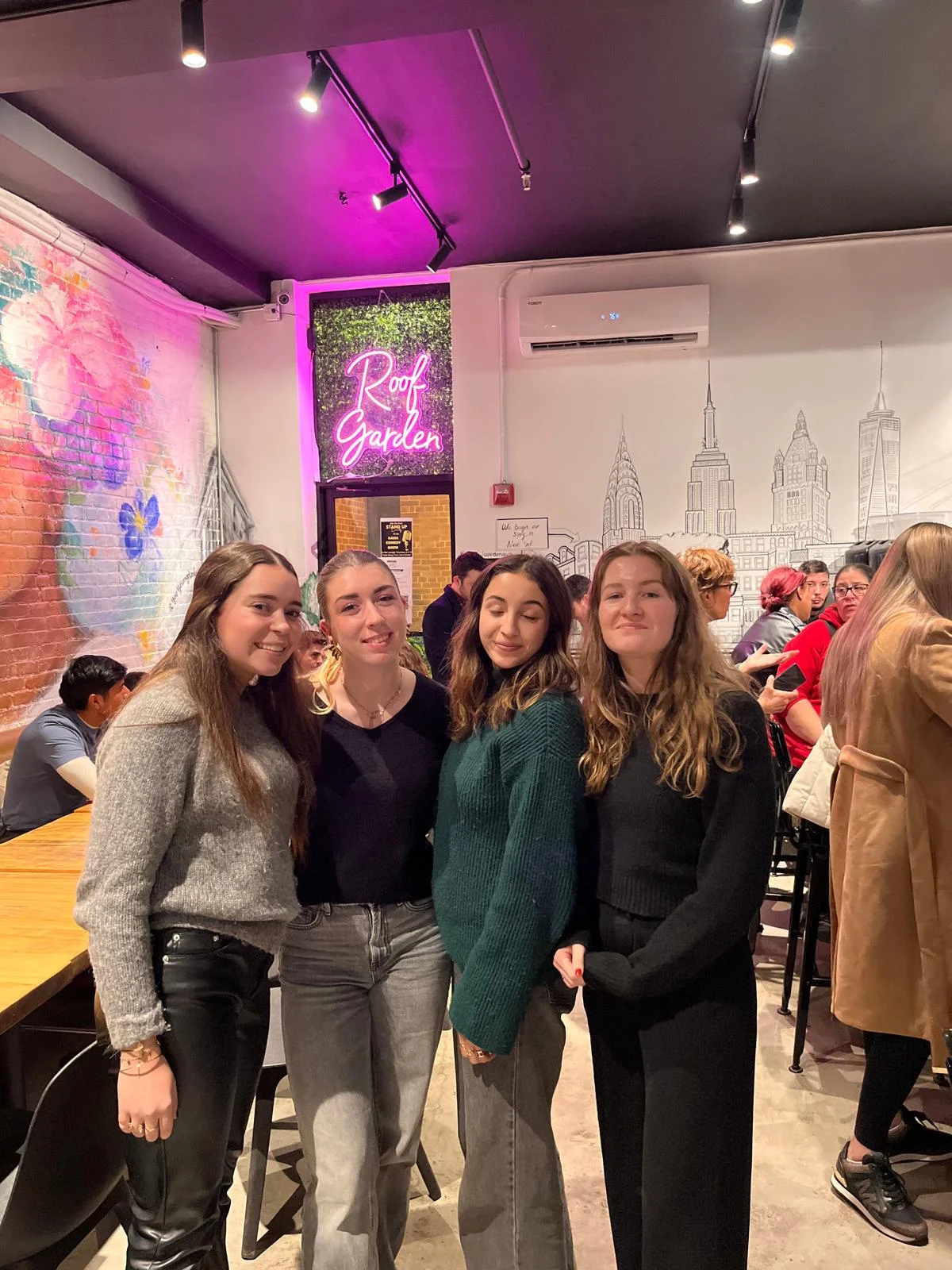Group of friends enjoying a night out in a vibrant restaurant interior