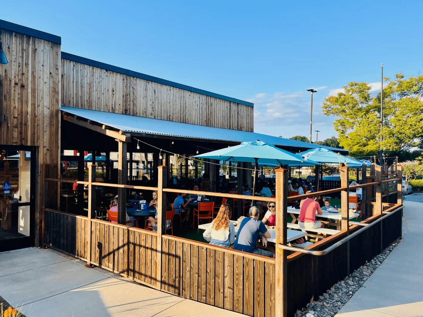 Outdoor dining area with colorful umbrellas and wooden decor