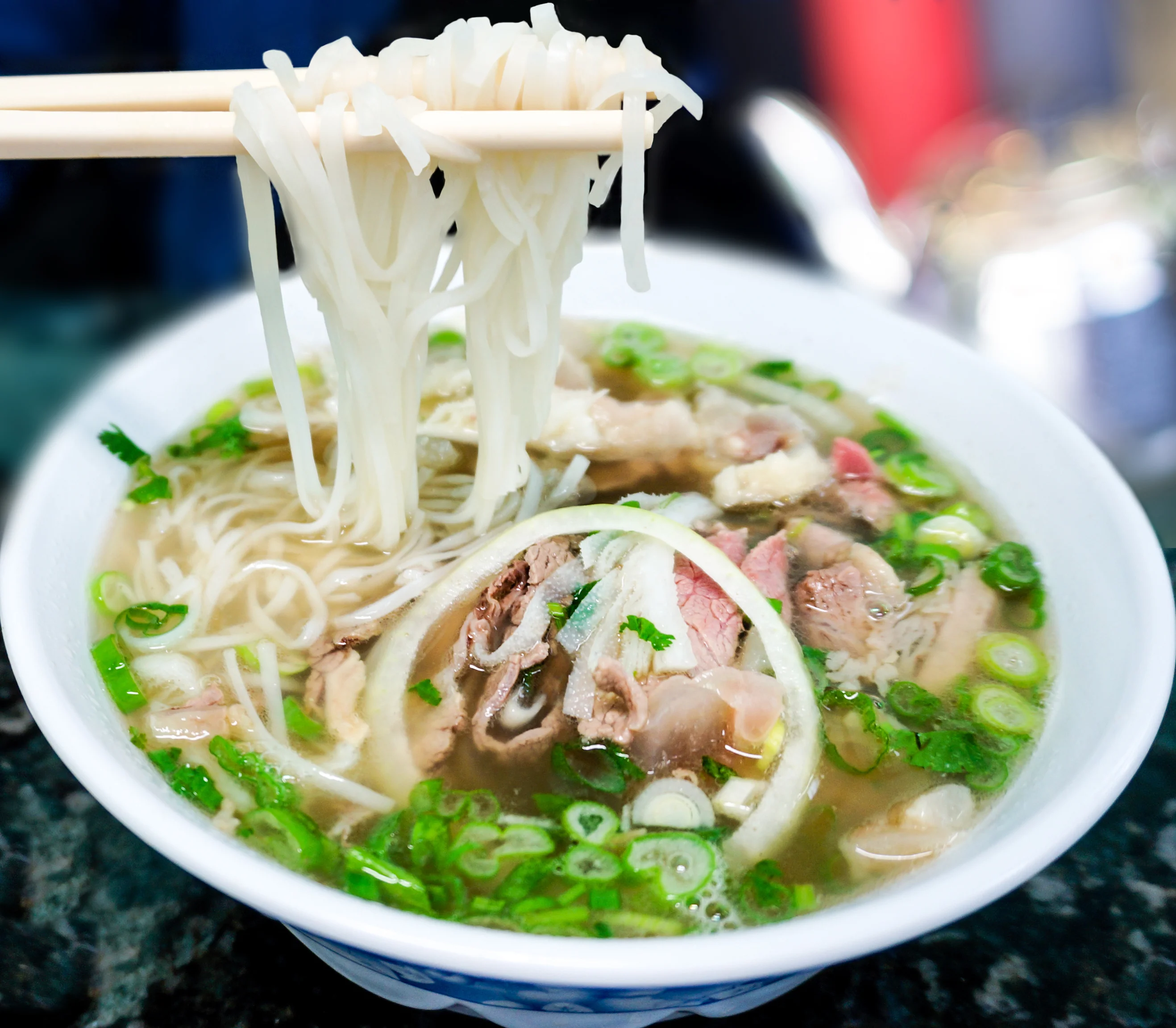Bowl of Vietnamese pho with beef and fresh herbs