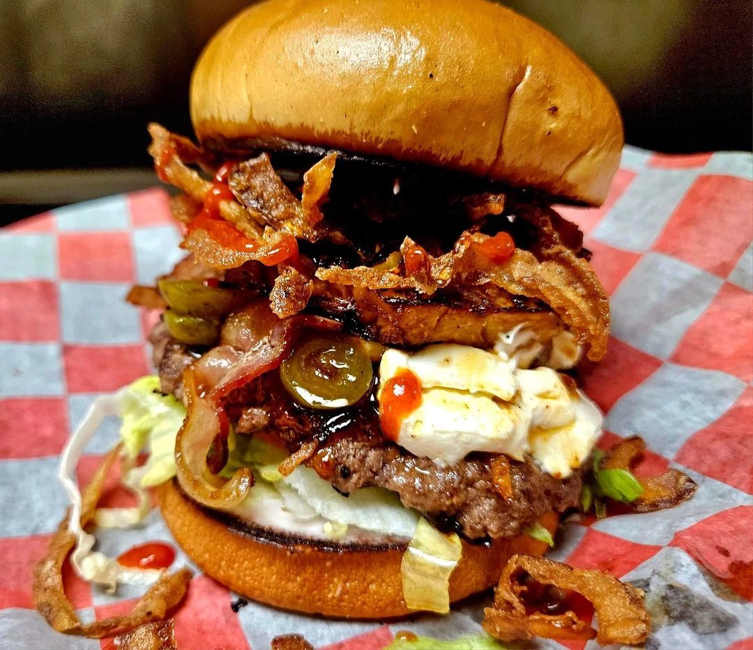 Juicy American cheeseburger with crispy bacon and jalapeños