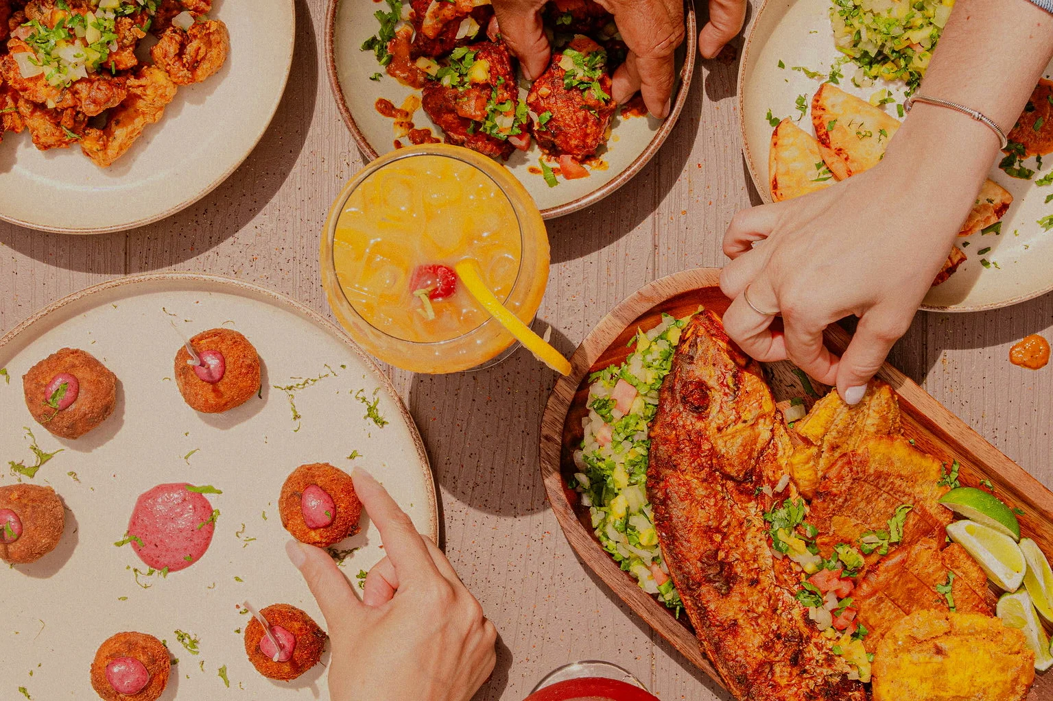 Colorful platter of Latin American seafood with sides and drinks