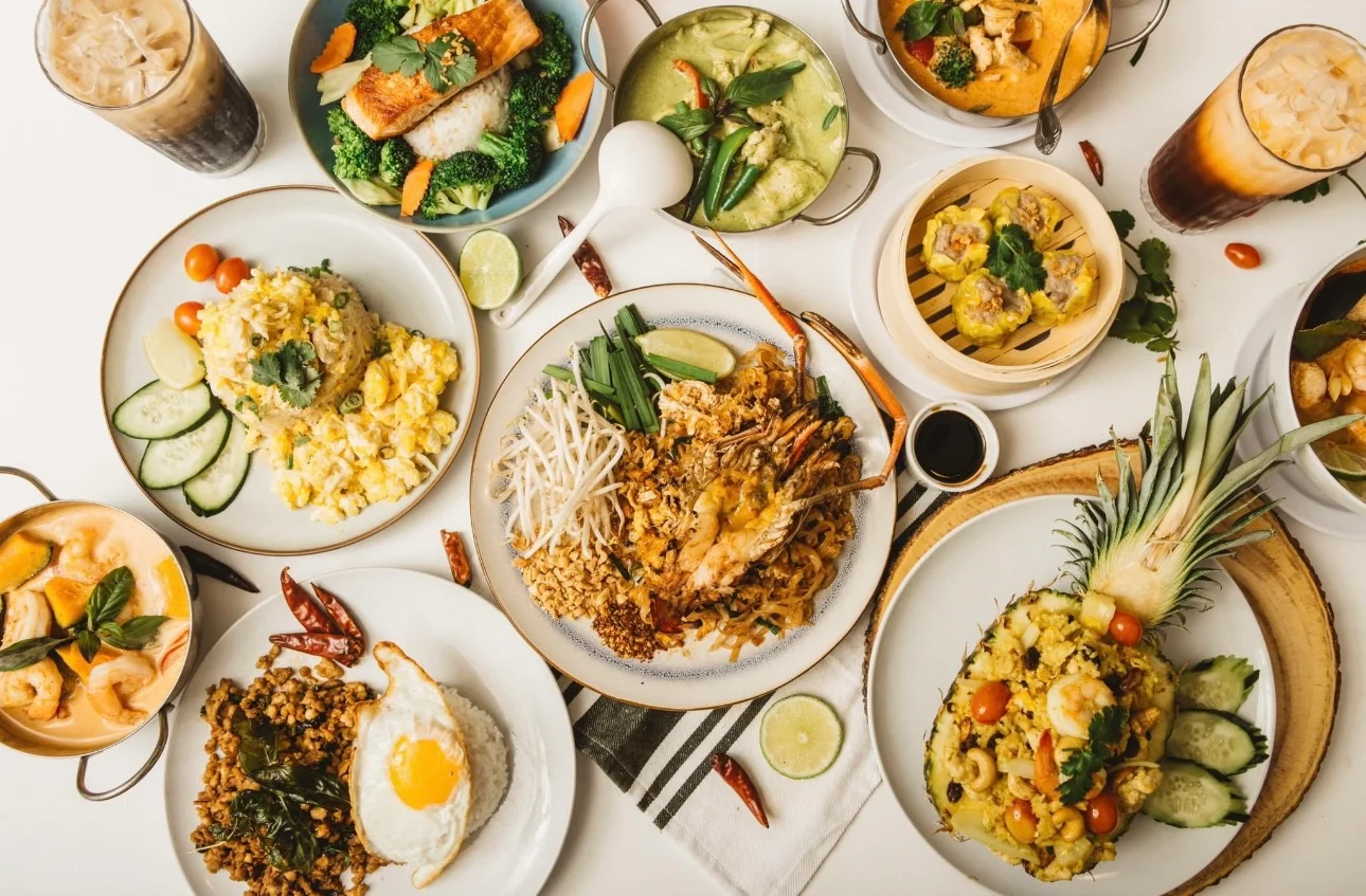 Assorted Thai dishes including pad thai and green curry