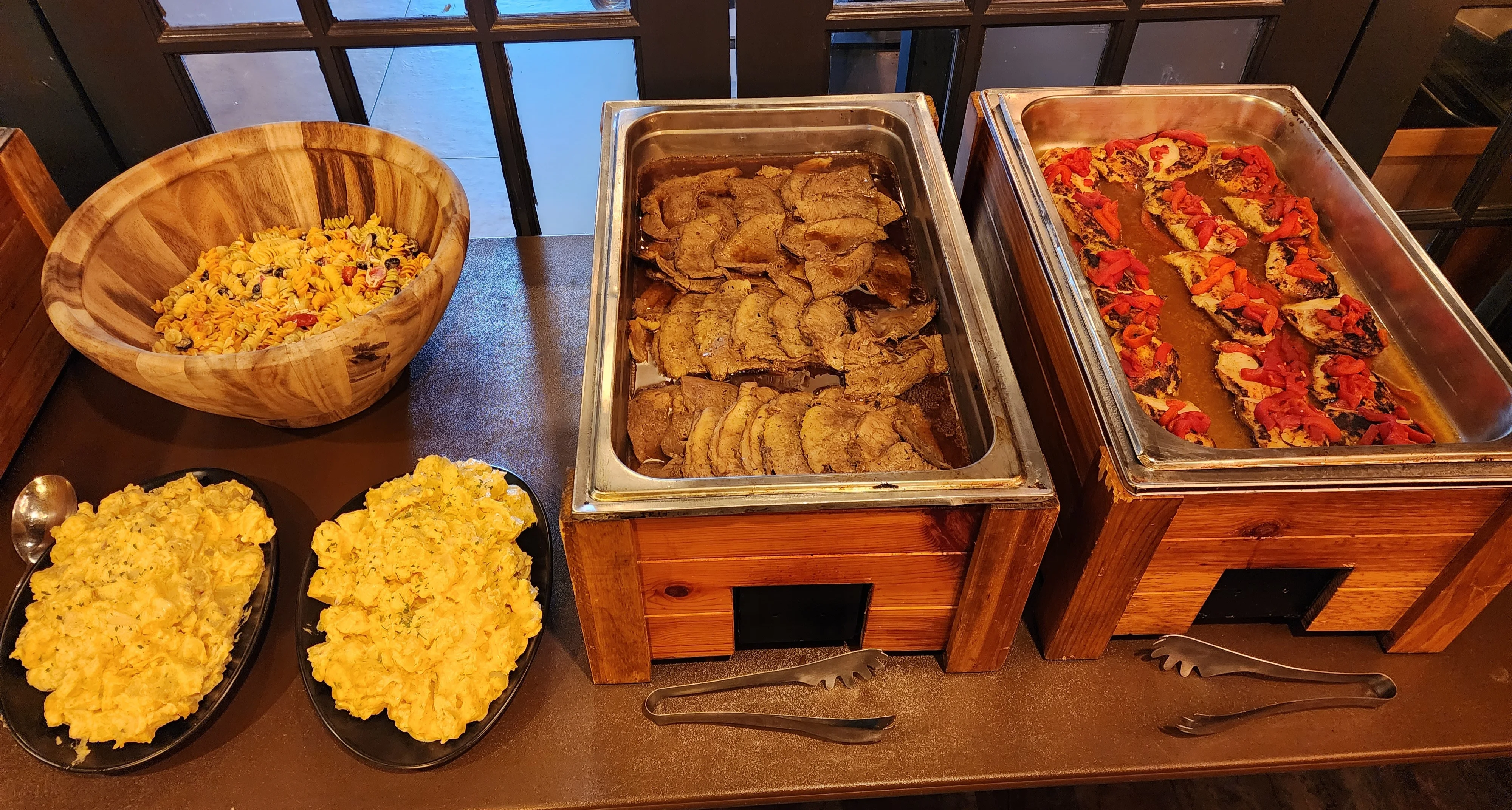 Assorted buffet dishes including beef and pasta salad