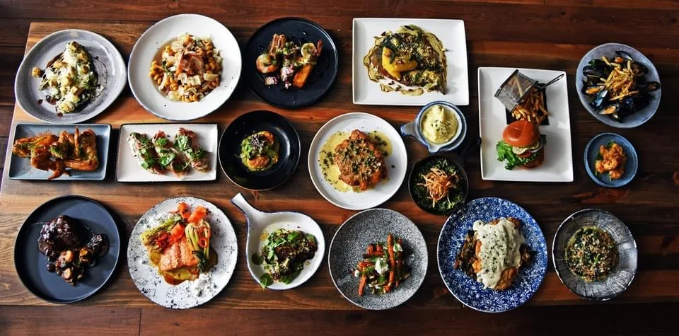 rustic table full of plates of delicious food from The 1894 Lodge