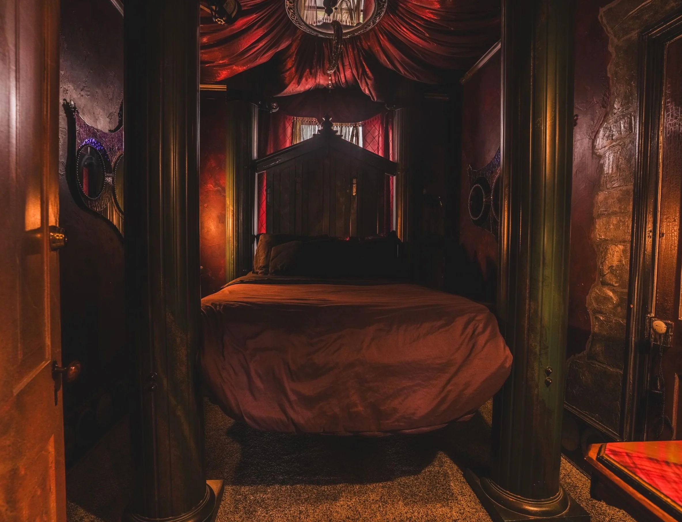 Cozy bedroom with dark decor and a four-poster bed.