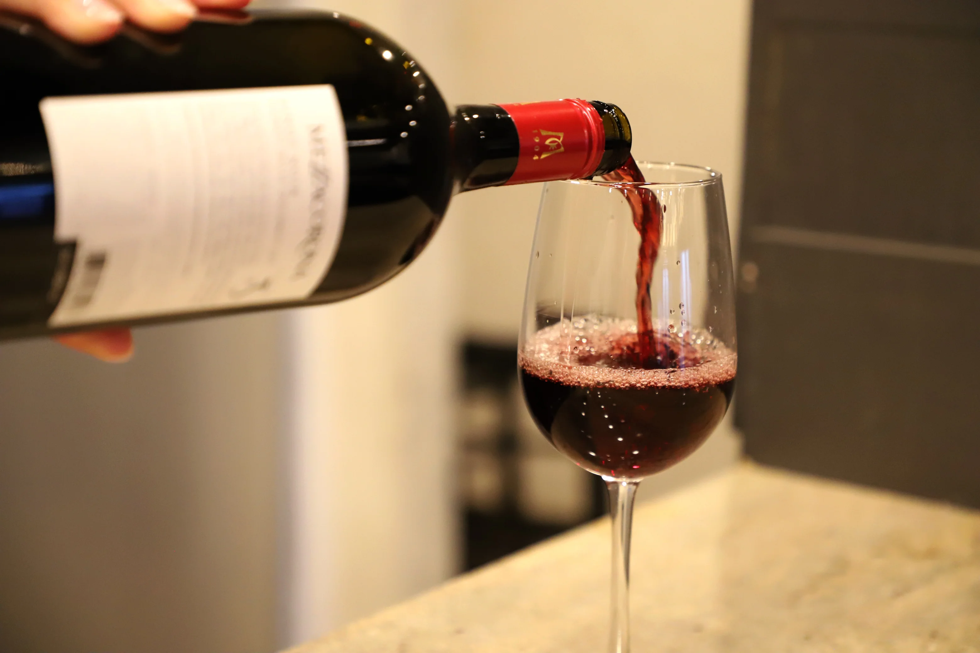 Pouring red wine into a glass at a restaurant
