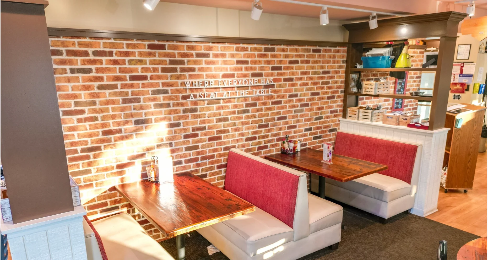 Cozy restaurant interior with brick wall and booth seating