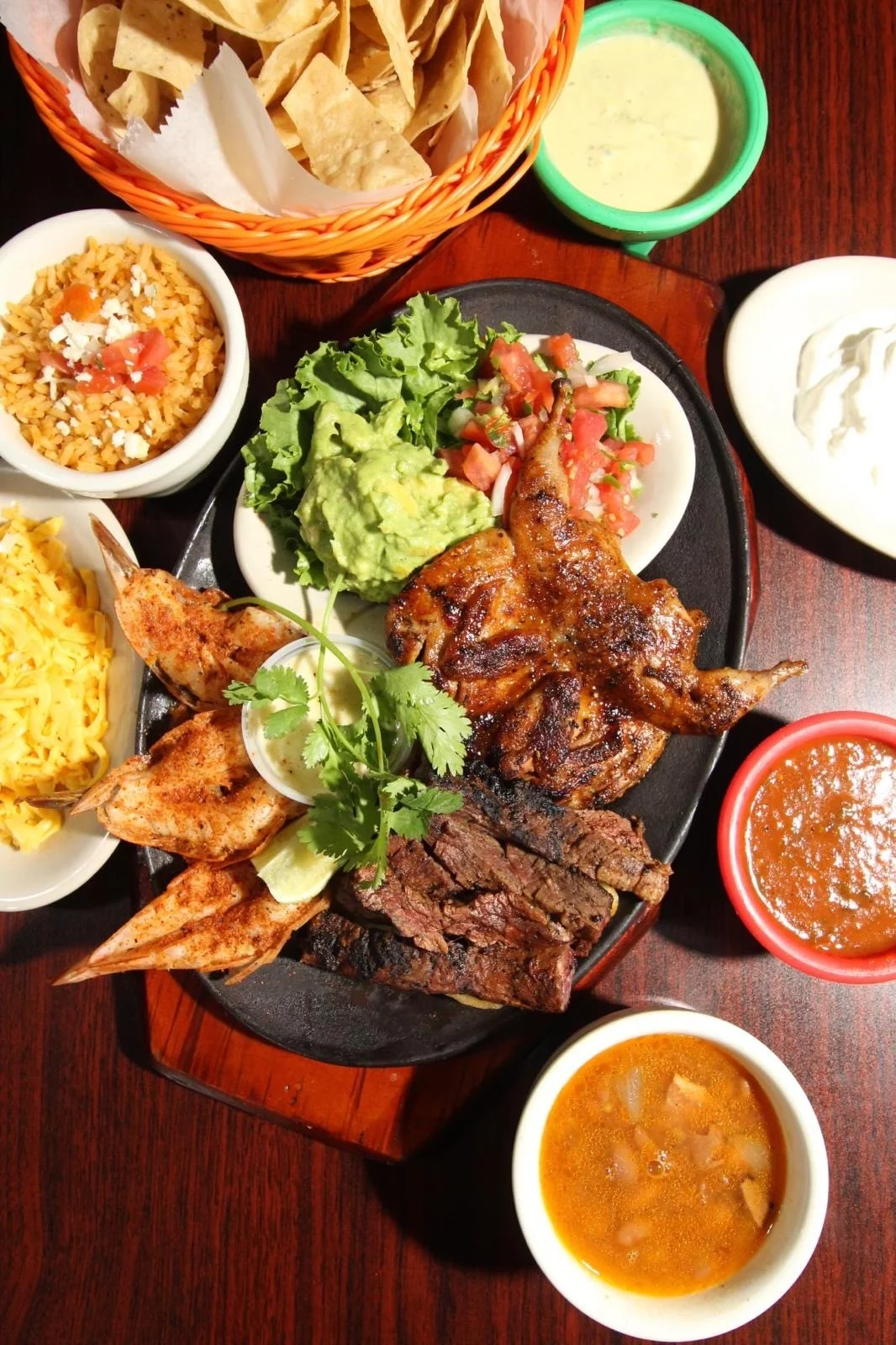 Sizzling Mexican fajitas platter with grilled meats and sides