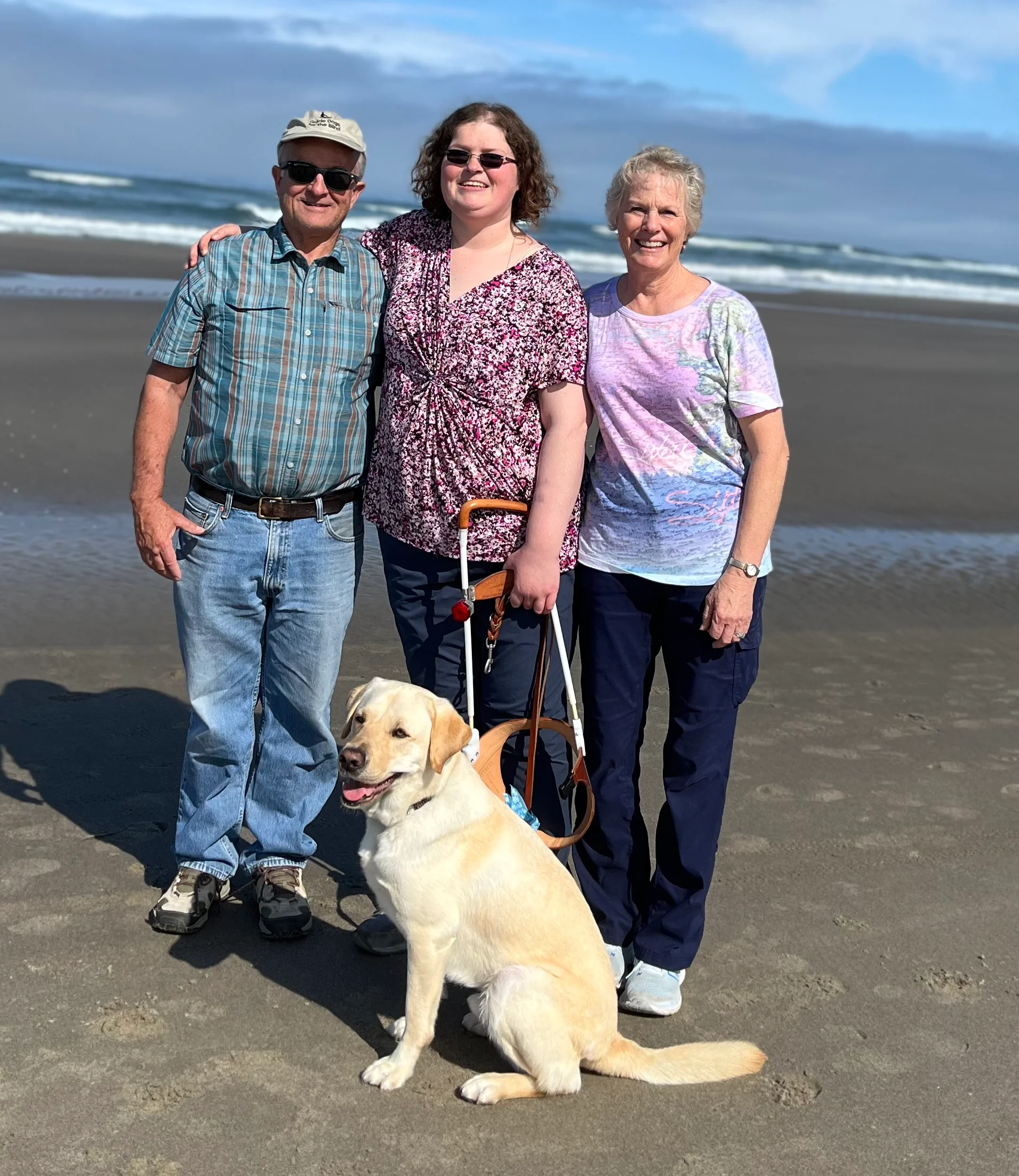 Family enjoying a day at the beach with a dog