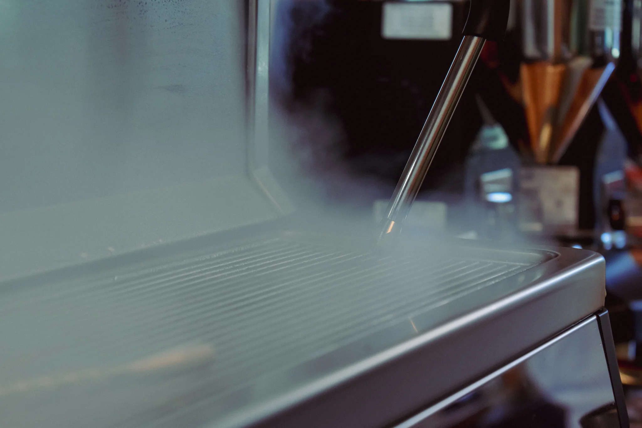 Steam rising from a commercial espresso machine