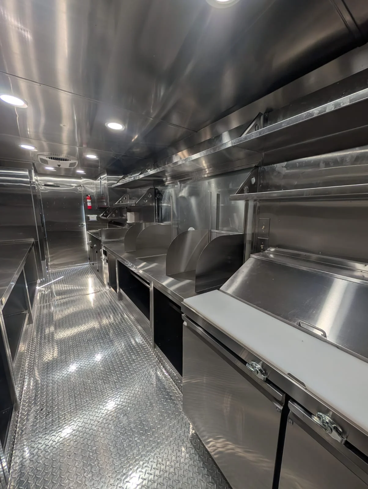Modern commercial kitchen interior with stainless steel equipment