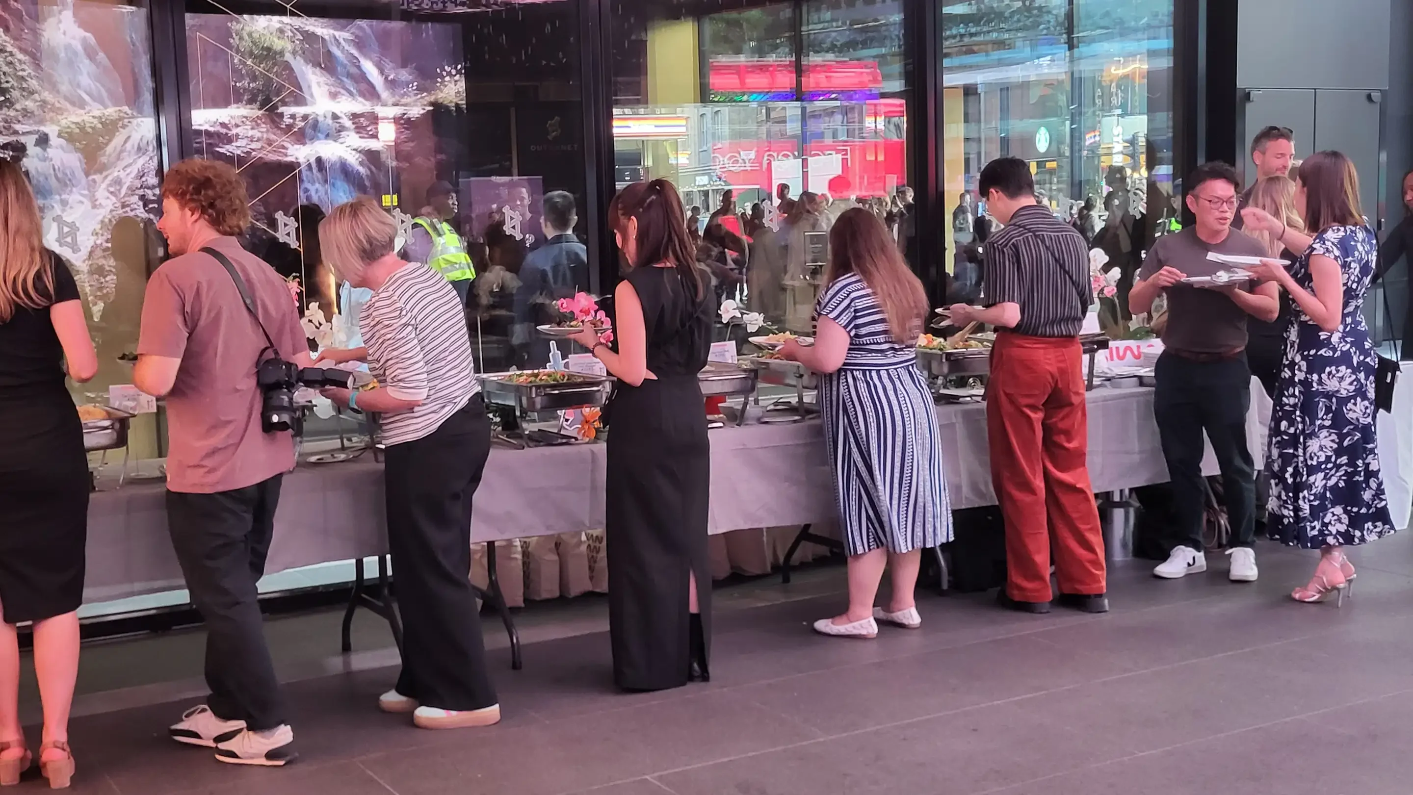 Guests enjoying a buffet spread at a modern restaurant event