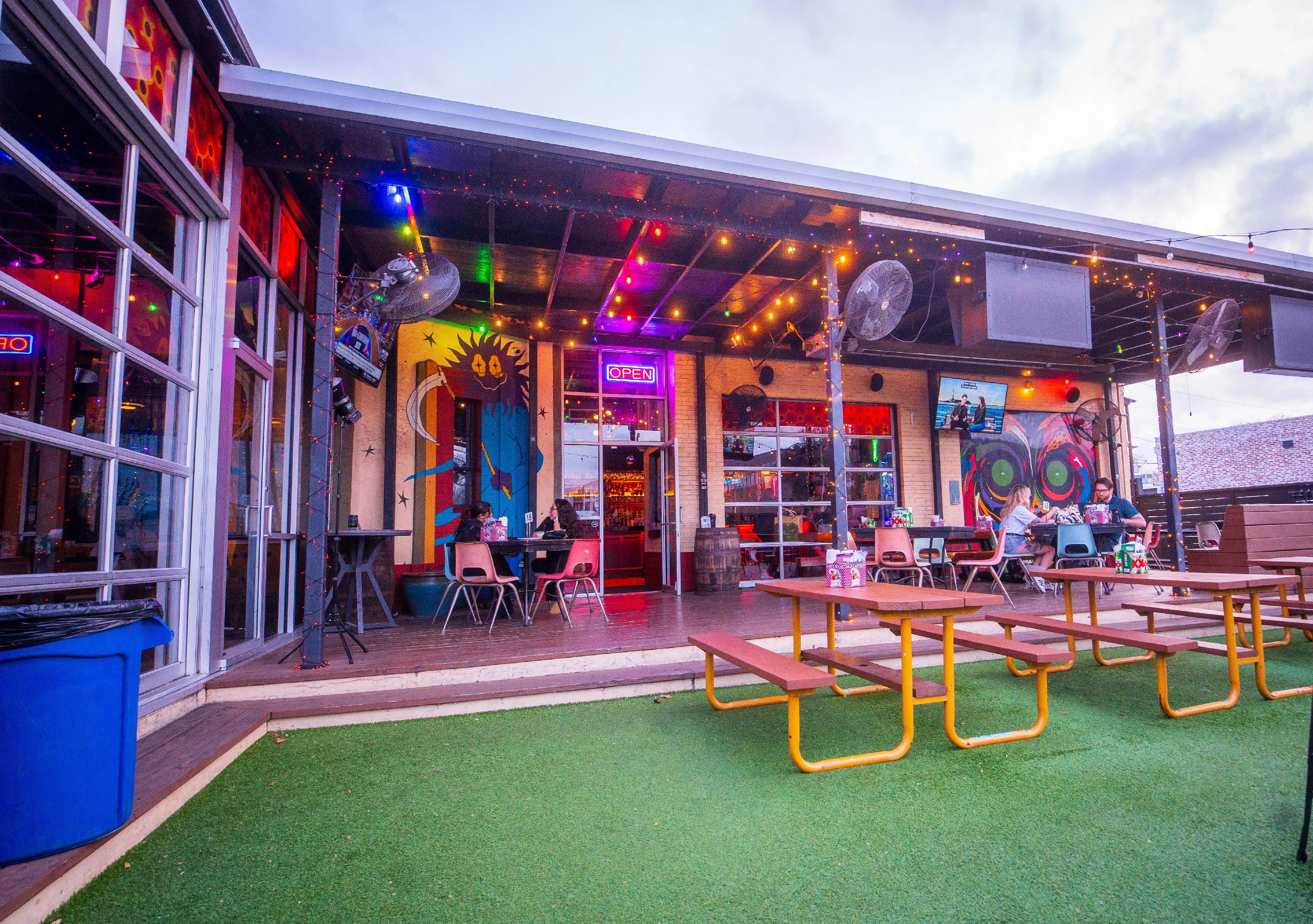 Vibrant outdoor dining area with colorful decor and seating