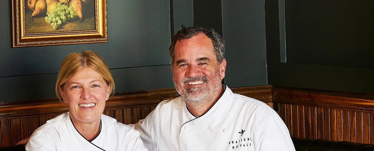 Chefs seated in an elegant restaurant dining room