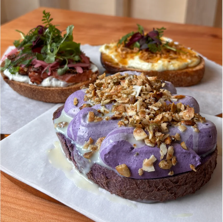 Assortment of gourmet open-faced toasts with ube cream and toppings