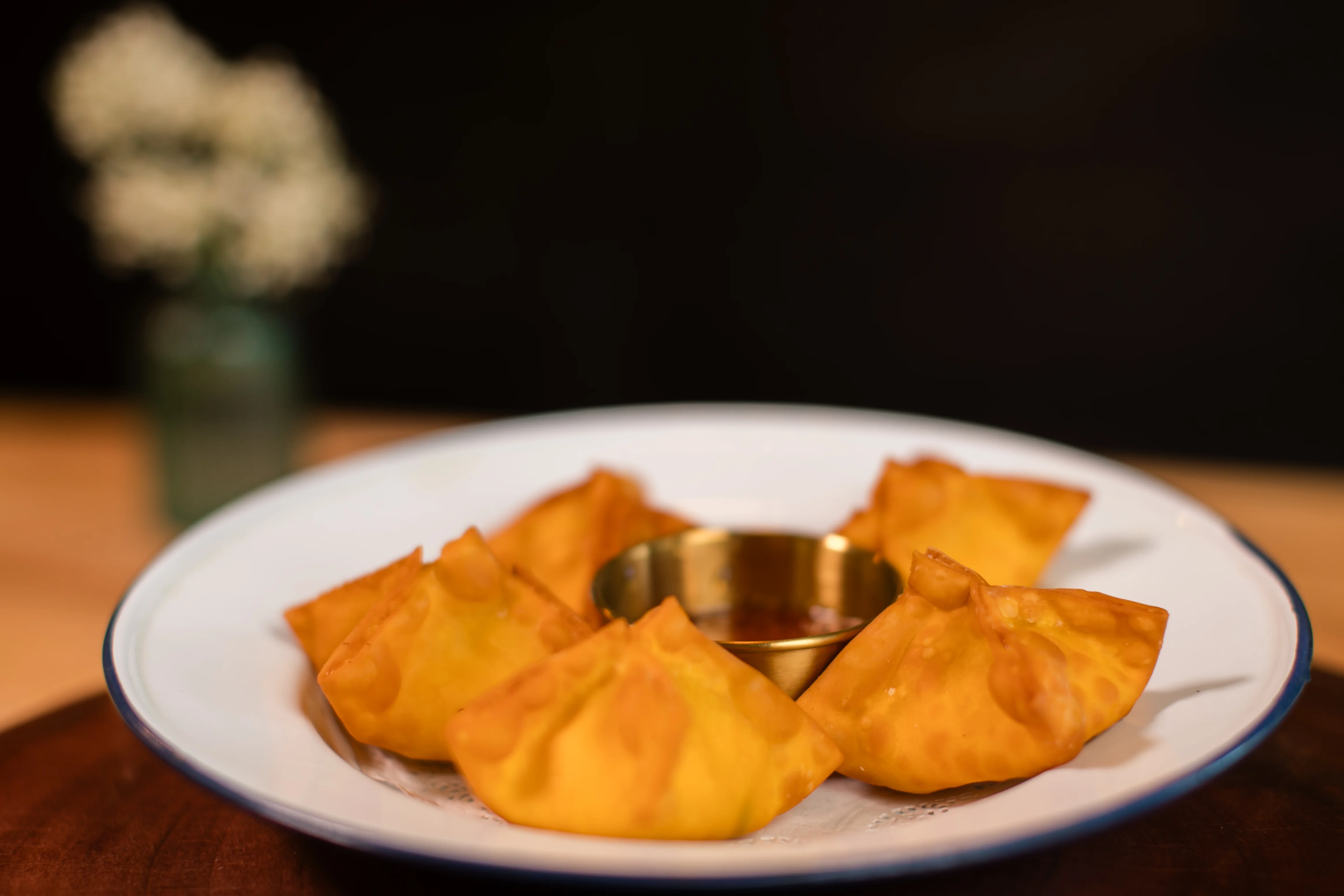Crispy Indian samosas served with dipping sauce
