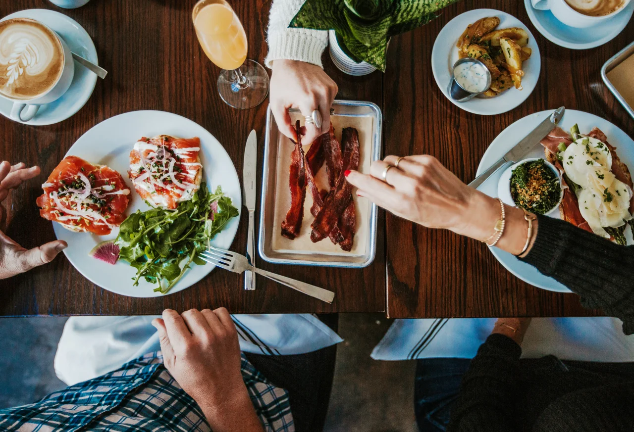 Brunch spread featuring smoked salmon toast and crispy bacon