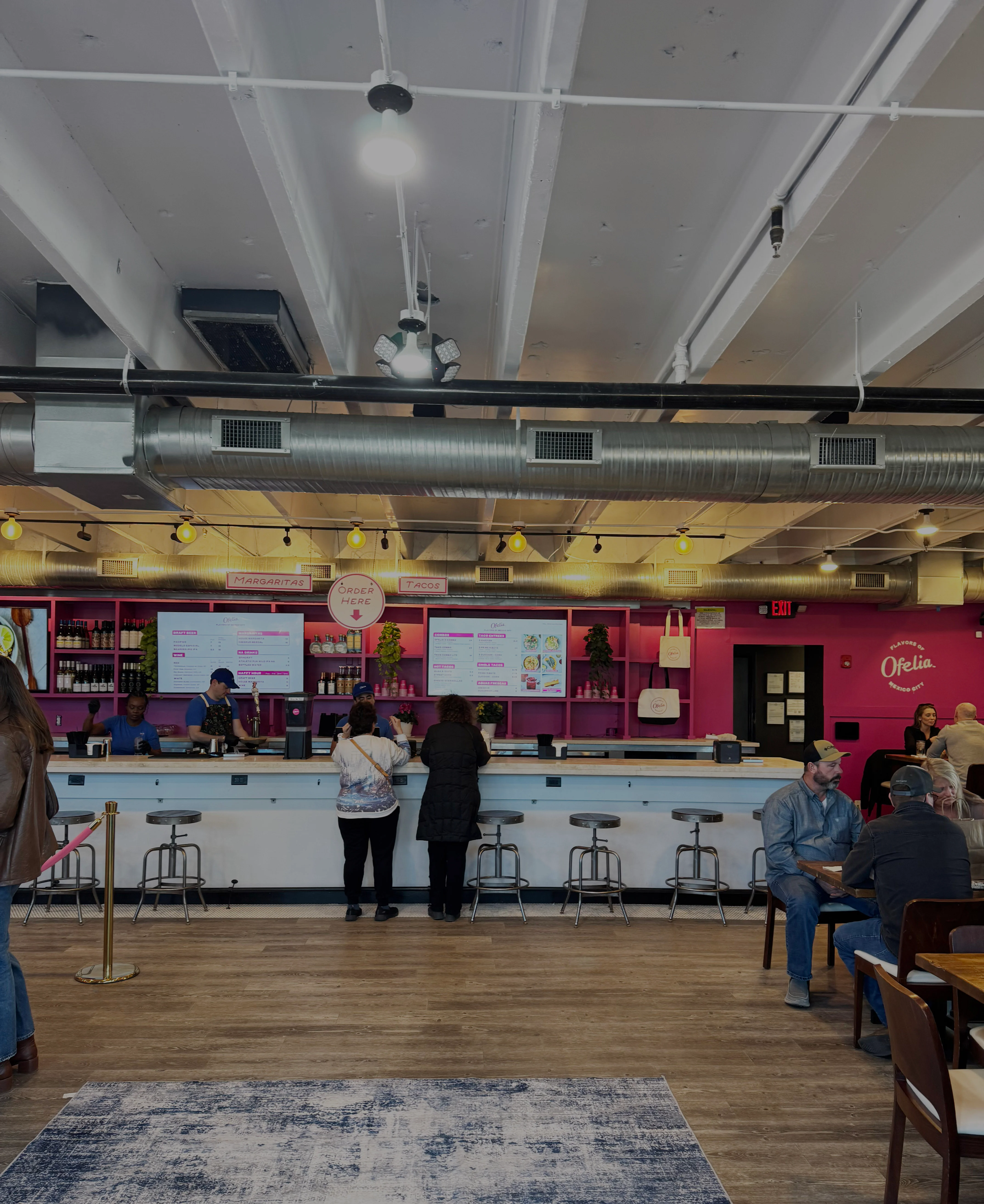 Modern restaurant interior with vibrant decor and a bar counter