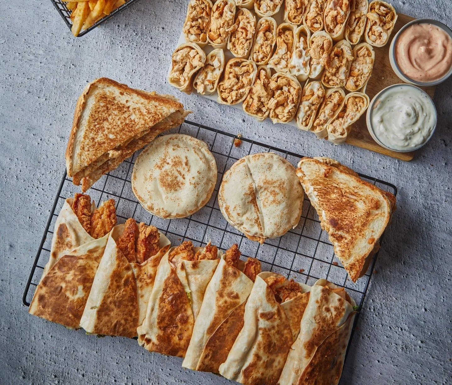 Crispy chicken wraps and quesadillas on a wire rack