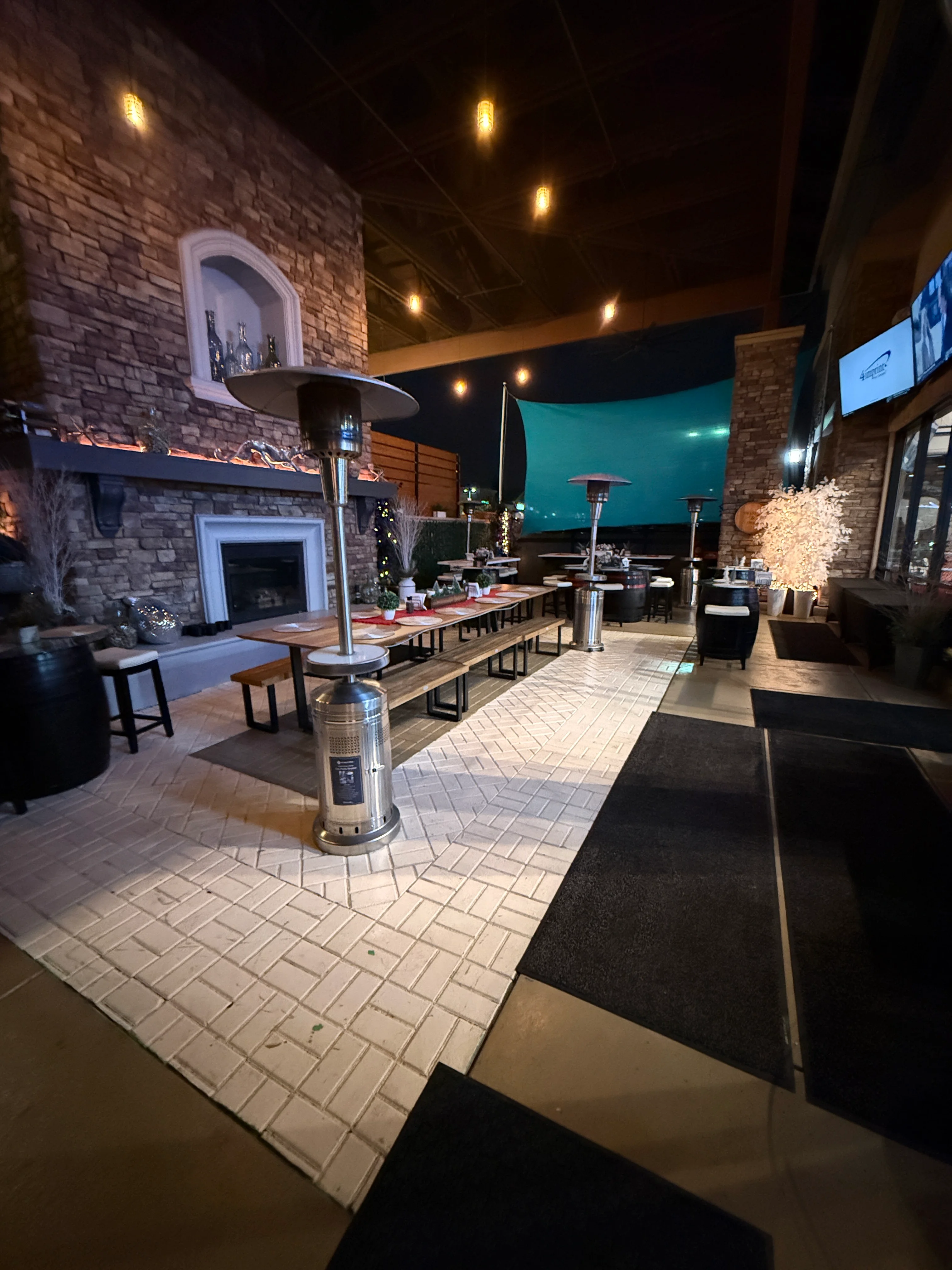 Cozy outdoor dining area with heaters and warm lighting