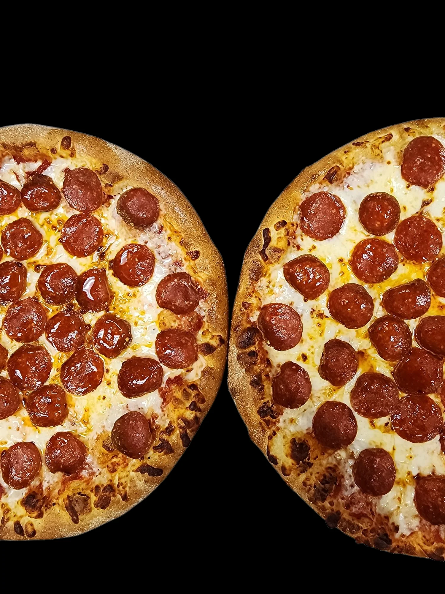 Two pepperoni pizzas with golden crusts