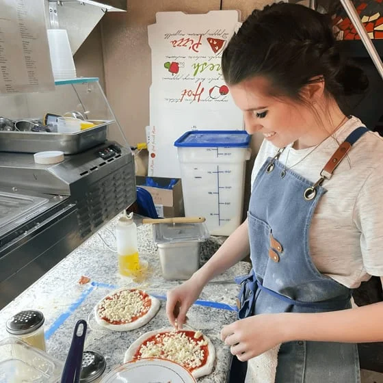 Pizza preparation in a cozy pizzeria kitchen