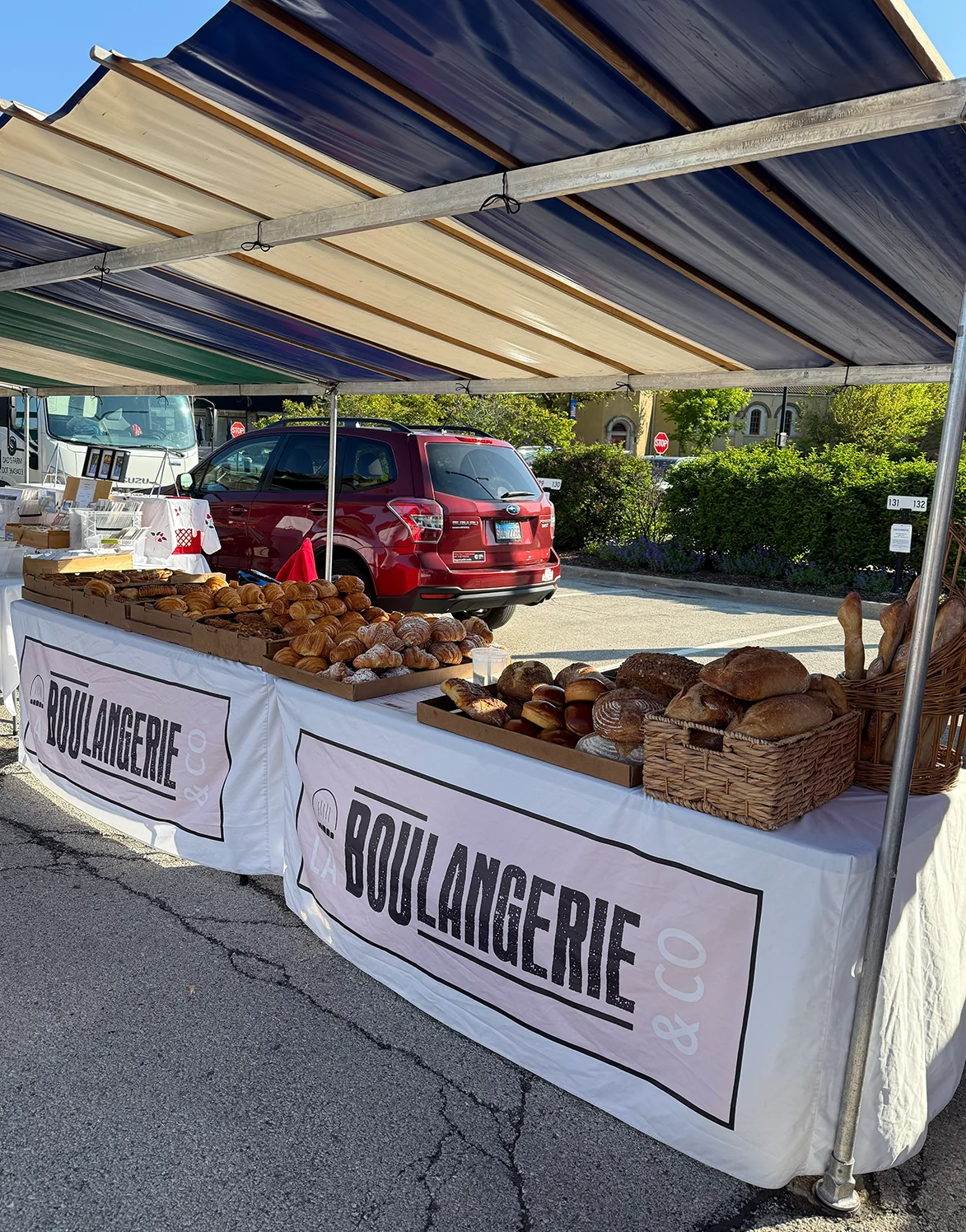 La Boulangerie & Co stall with fresh bread and croissants at a Chicago farmers market