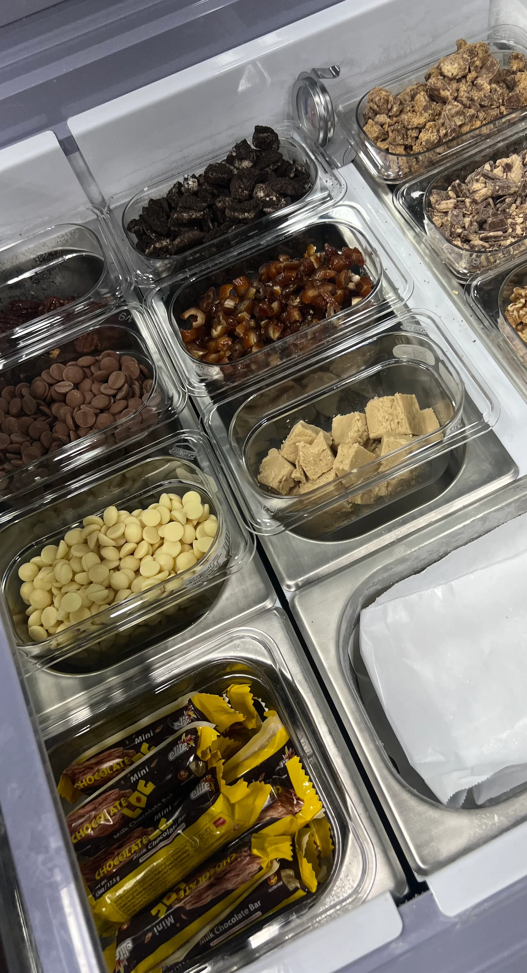 Variety of toppings for desserts in a restaurant display
