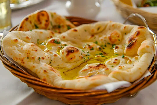 Freshly baked naan bread drizzled with olive oil