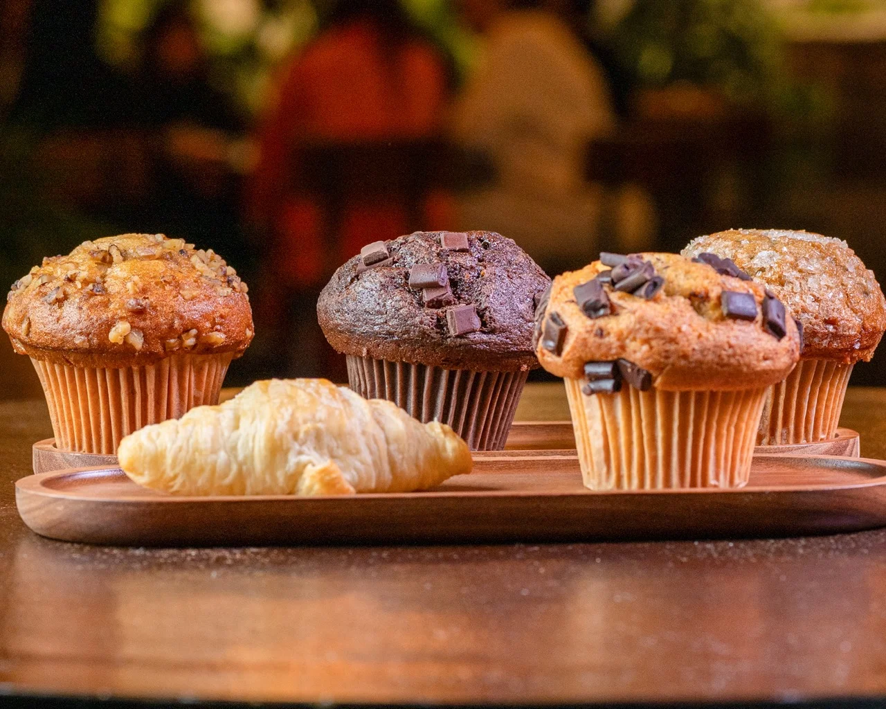 Chocolate chip muffin on a wooden board