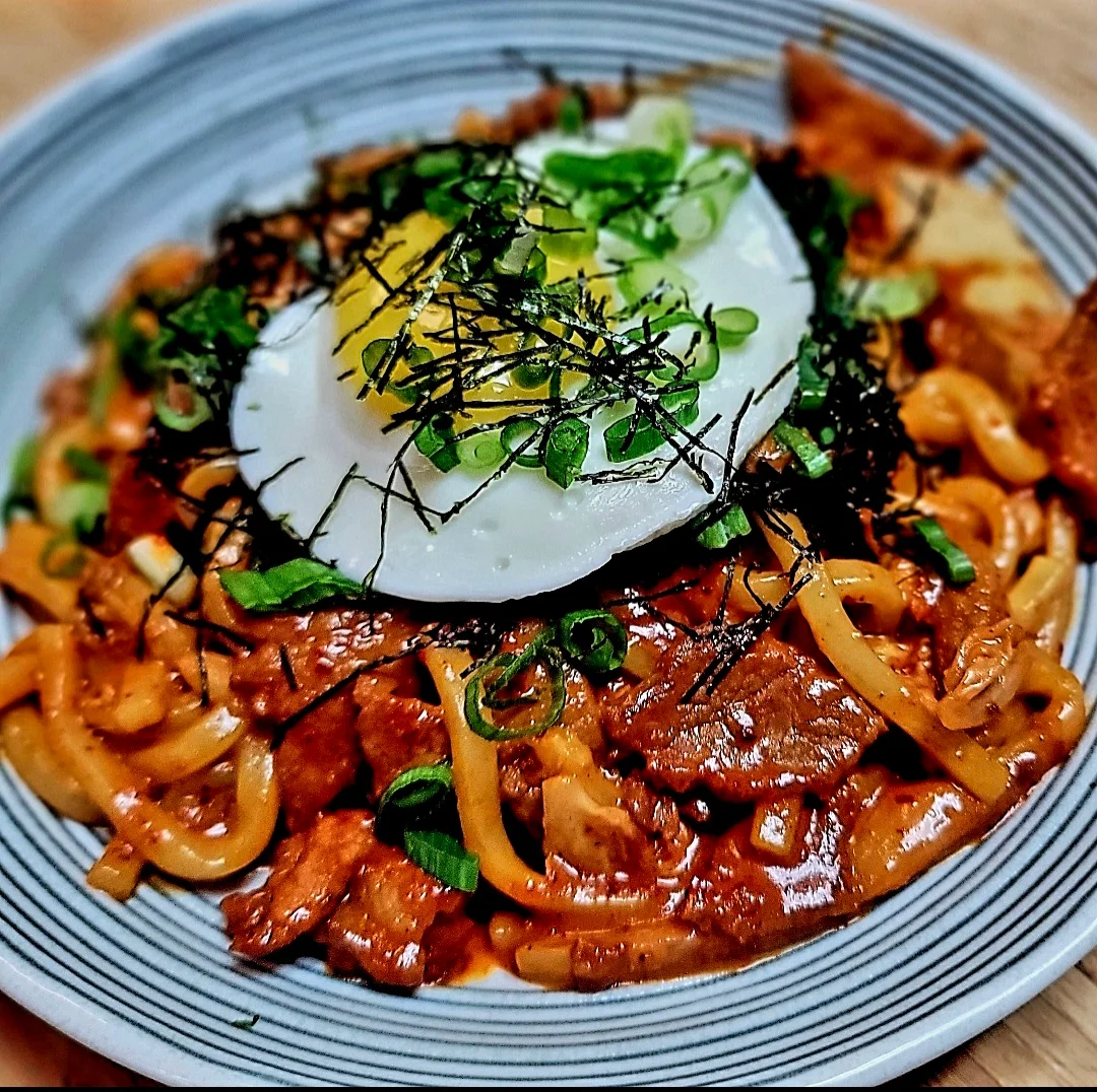 Korean jjajangmyeon topped with a fried egg and green onions