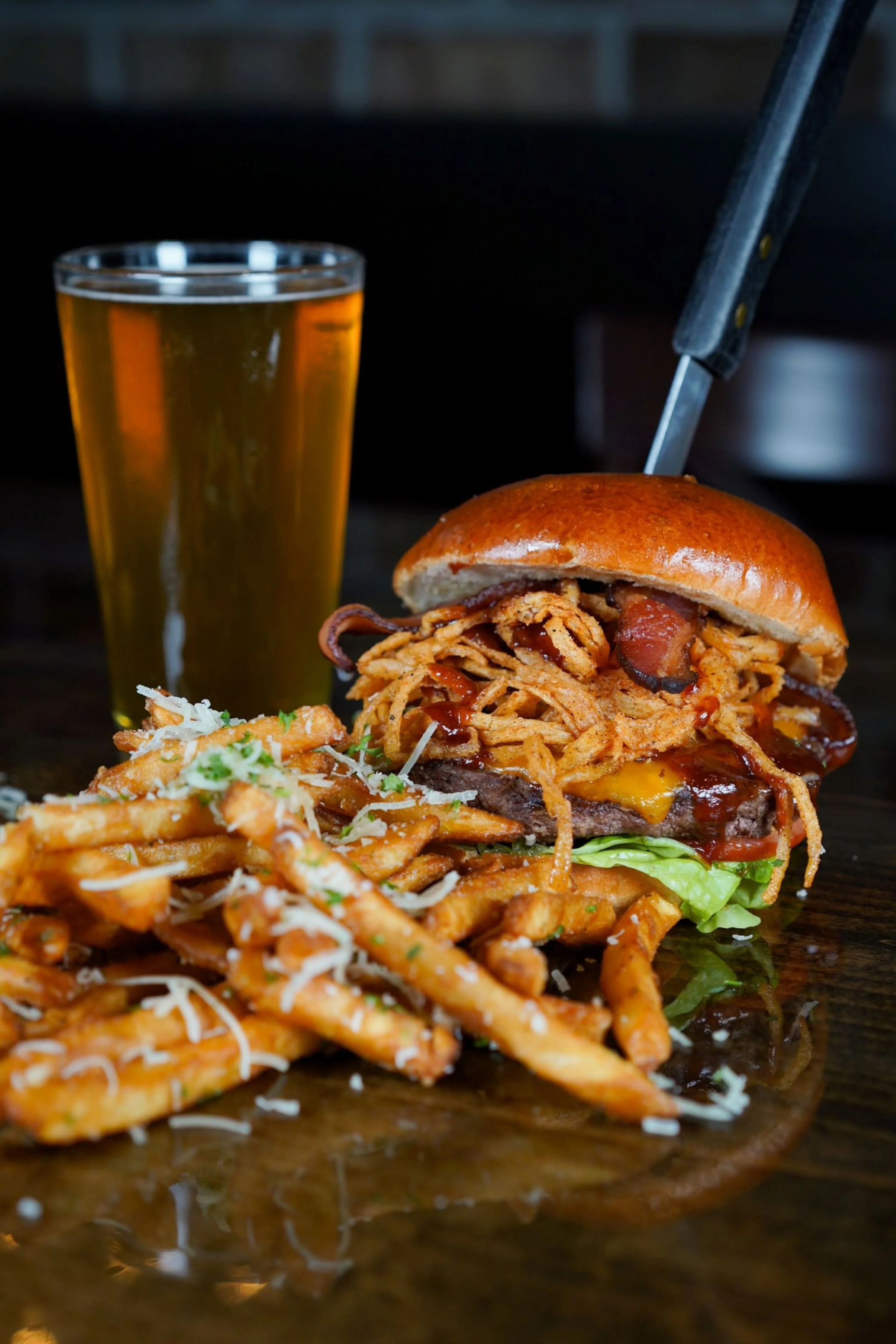 Juicy American cheeseburger with crispy fries and a cold beer