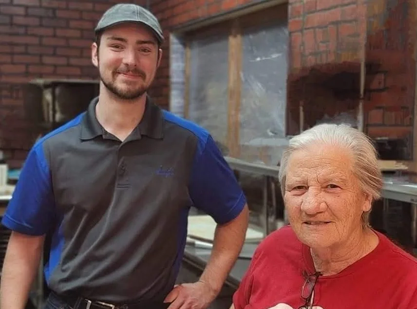 Friendly restaurant staff posing in a cozy kitchen