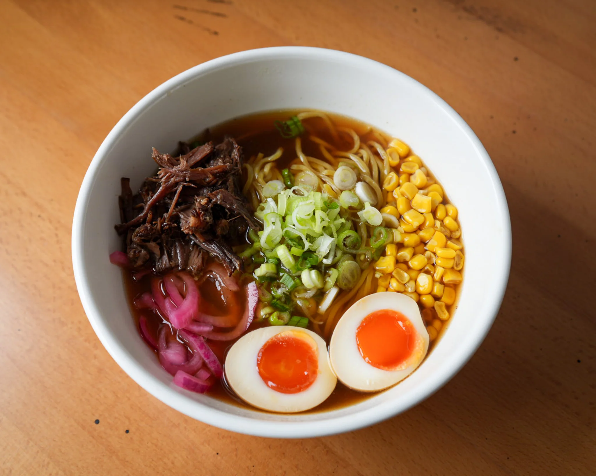 Japanese ramen bowl with tender beef and soft-boiled eggs
