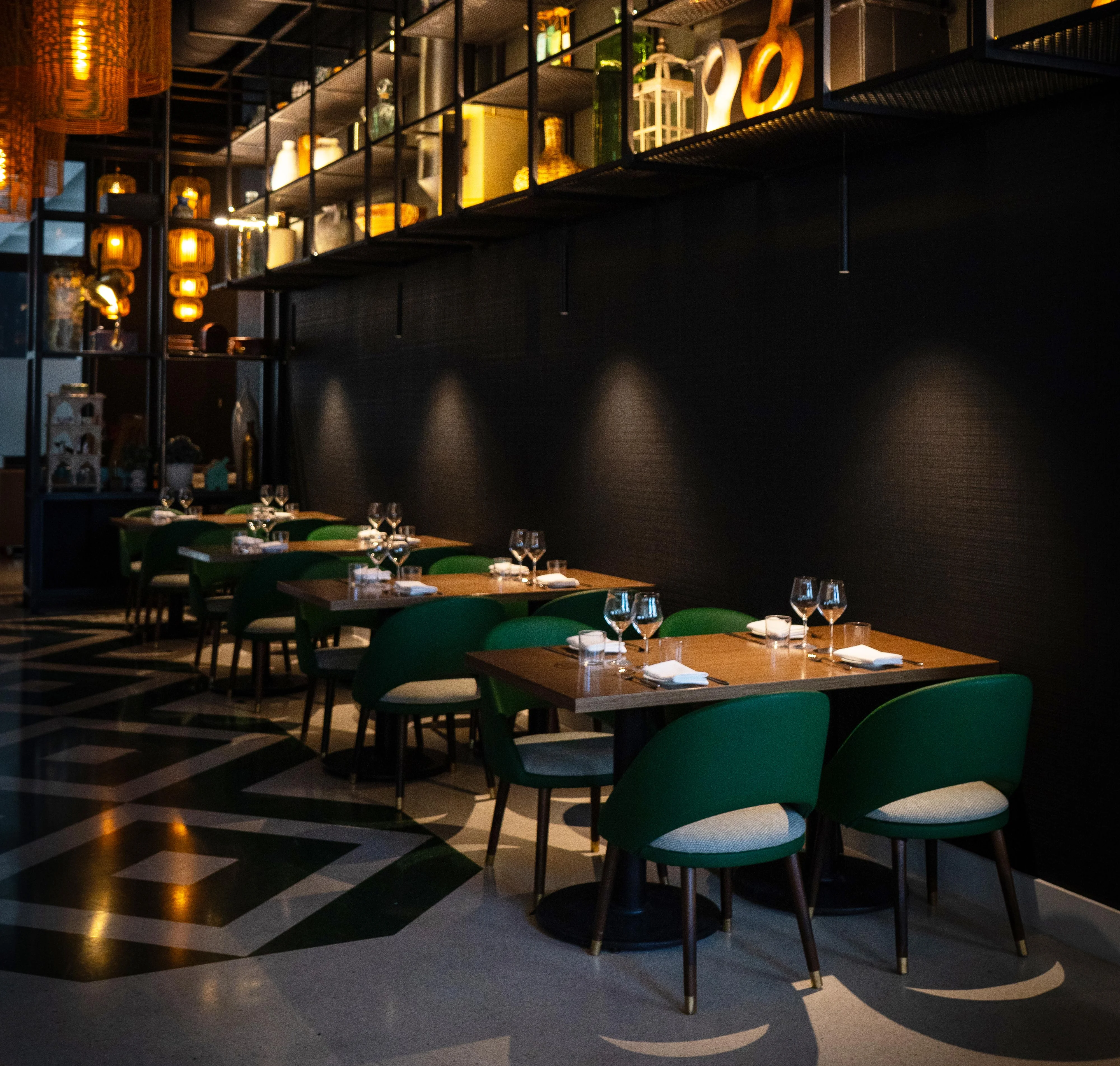 Stylish restaurant interior with green chairs and warm lighting
