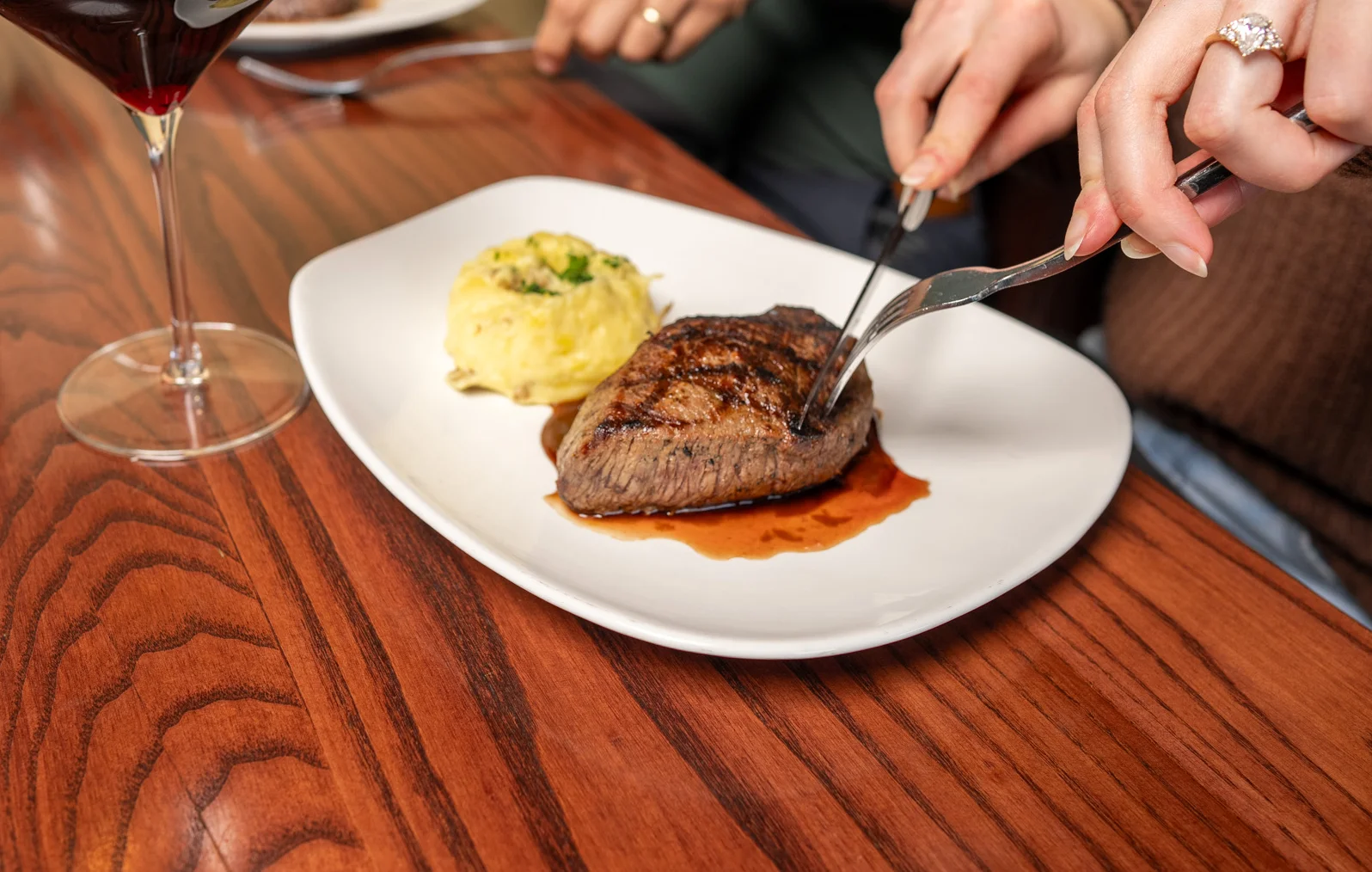 Grilled steak with creamy mashed potatoes in a cozy restaurant setting