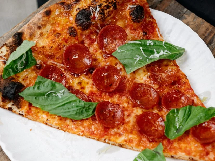 A slice of artisan pepperoni pizza served on a plate
