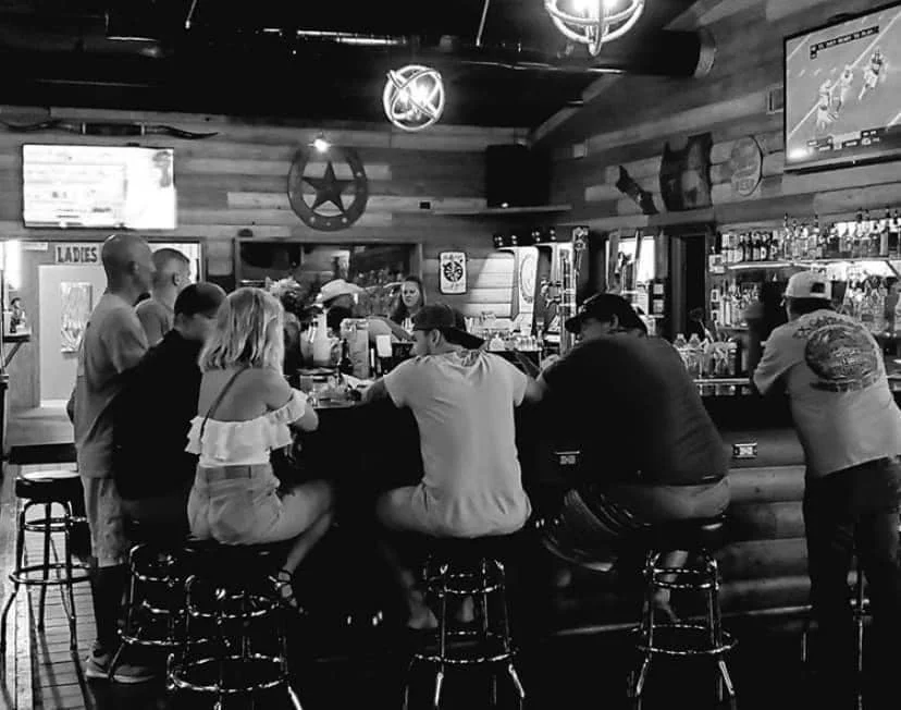 Cozy bar scene with patrons enjoying drinks and conversation