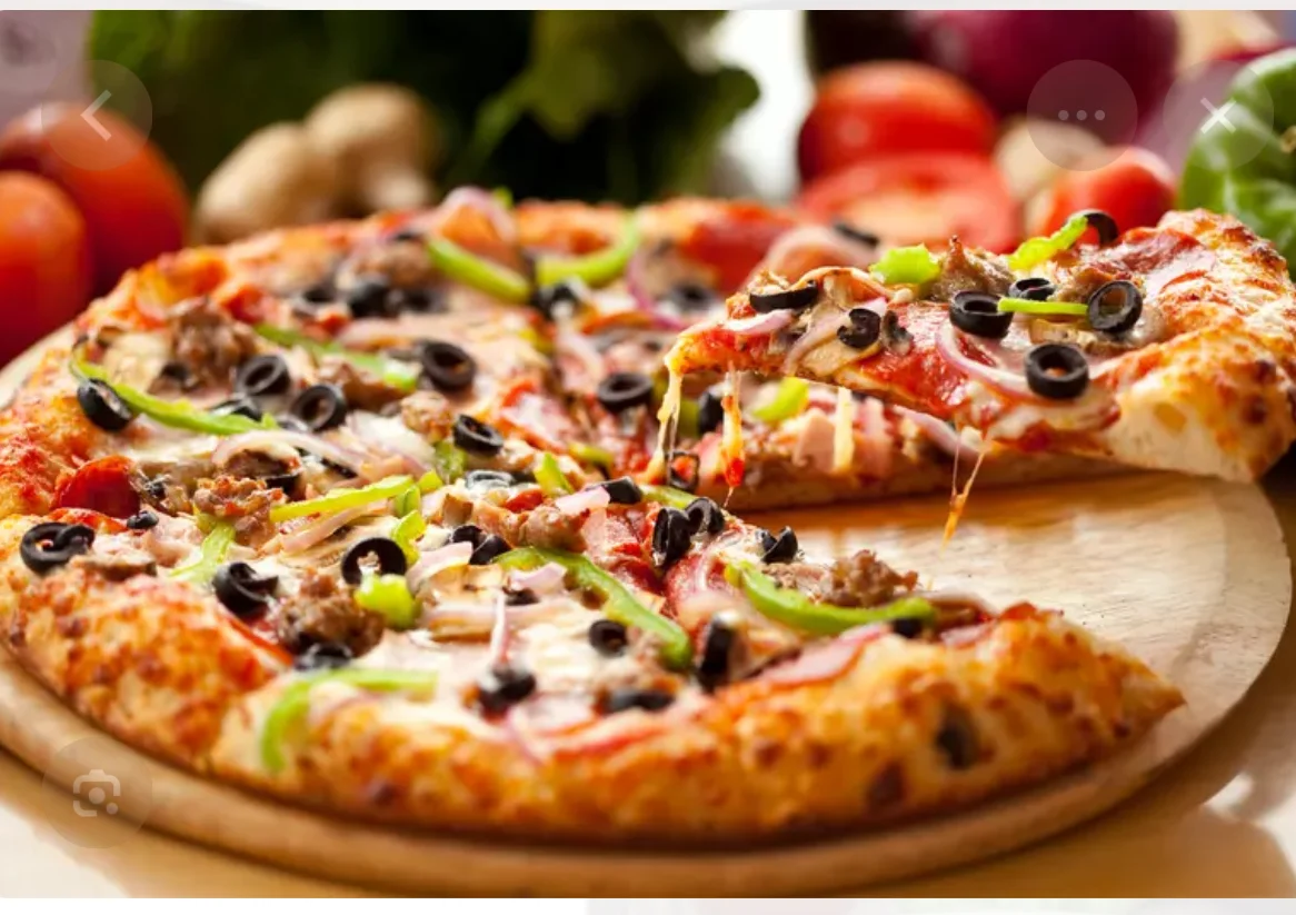 A detailed restaurant menu displaying various food categories including appetizers, pizzas, burgers, pasta, chicken dinners, seafood, and desserts.