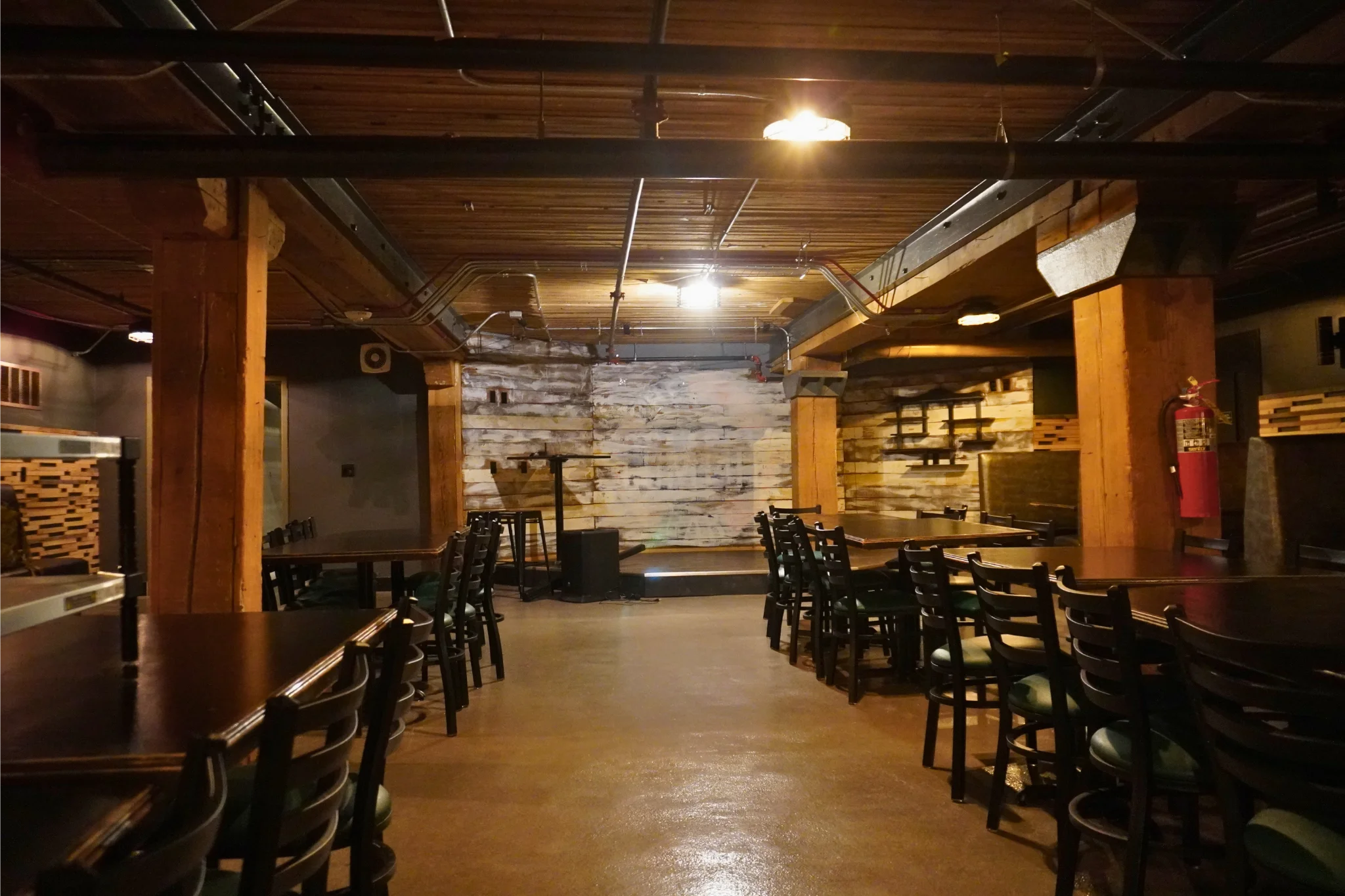 Cozy restaurant interior with wooden beams and warm lighting