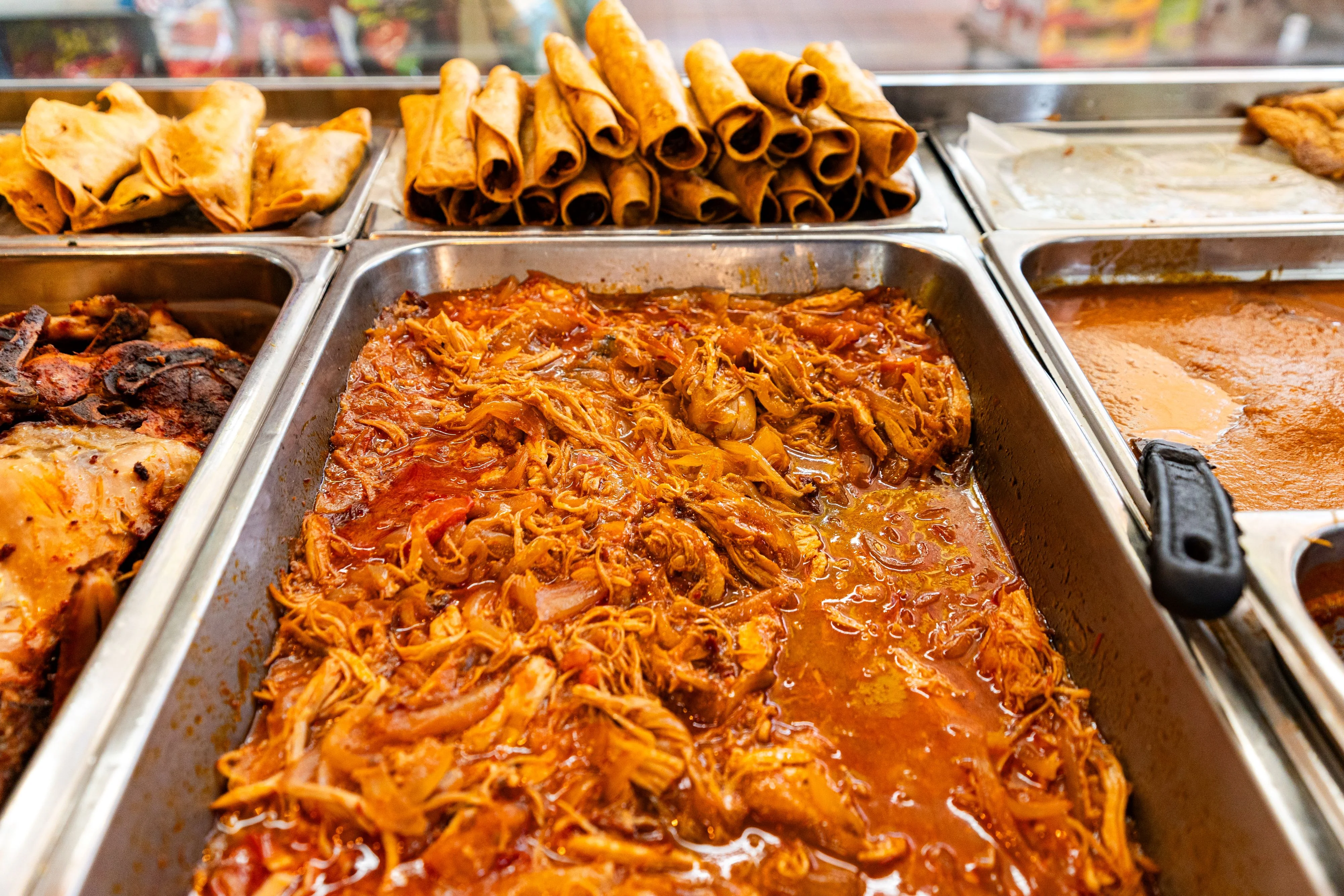 Savory Mexican shredded chicken in sauce with crispy taquitos