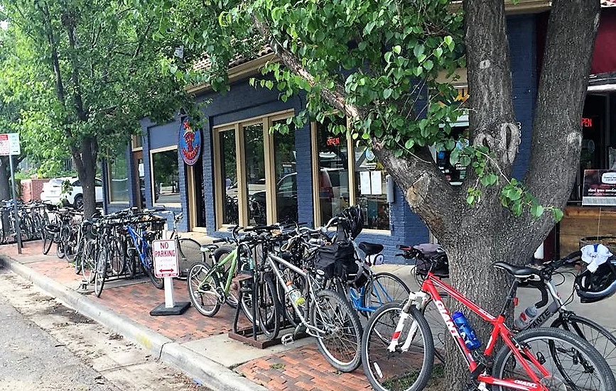 Bicycles parked outside a cozy restaurant with large windows