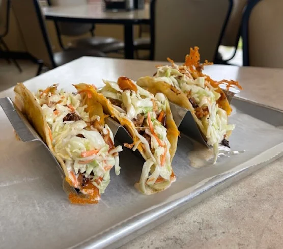 Crispy fish tacos topped with slaw