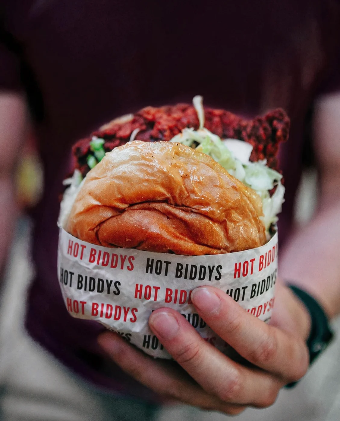 Delicious gourmet burger with fresh toppings on a wooden table