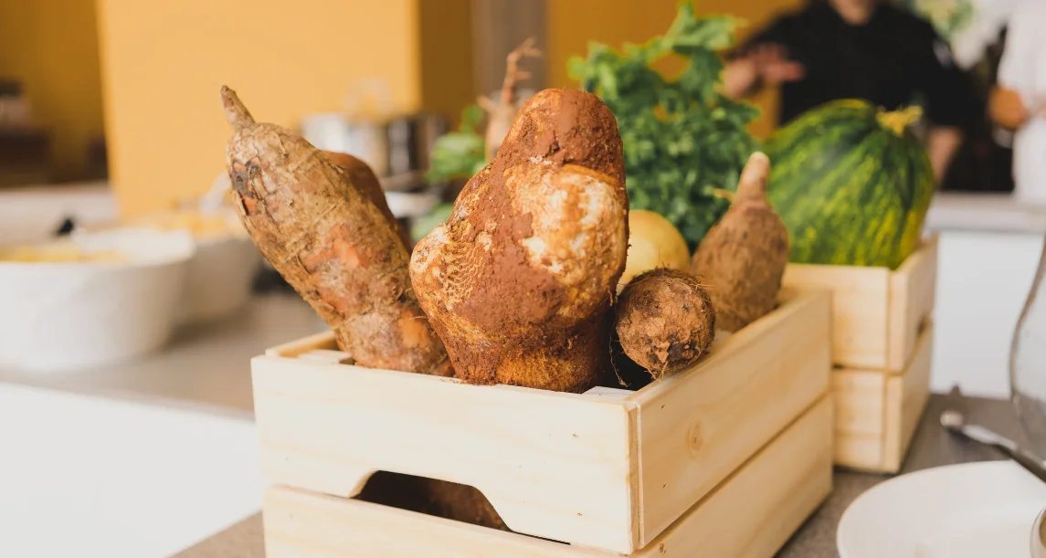 Fresh root vegetables in a wooden crate for farm-to-table cuisine
