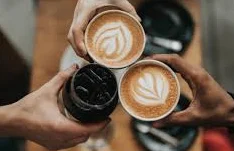 Coffee cups clinking together in celebration