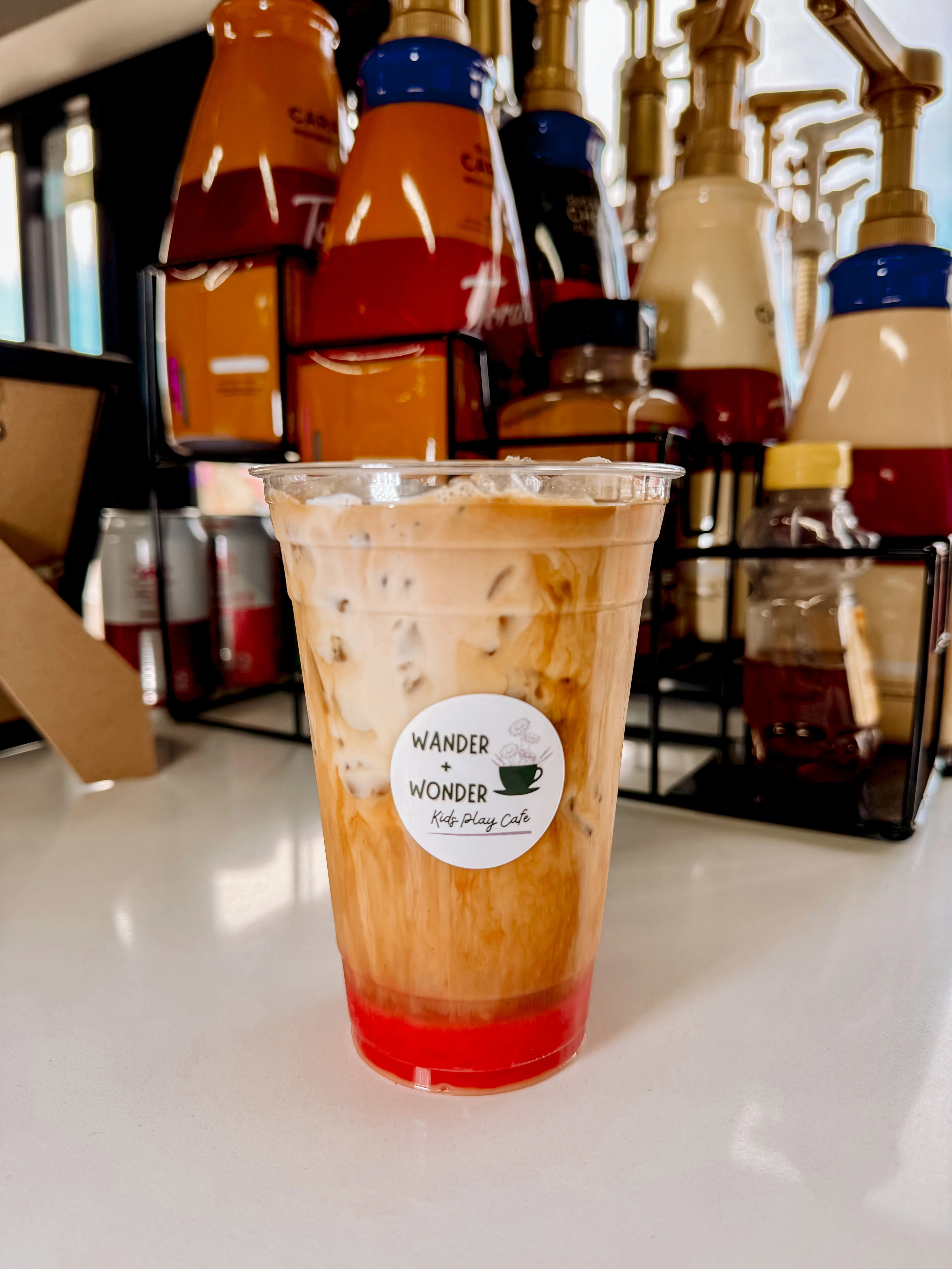 Iced coffee drink with vibrant layers at a kid-friendly cafe