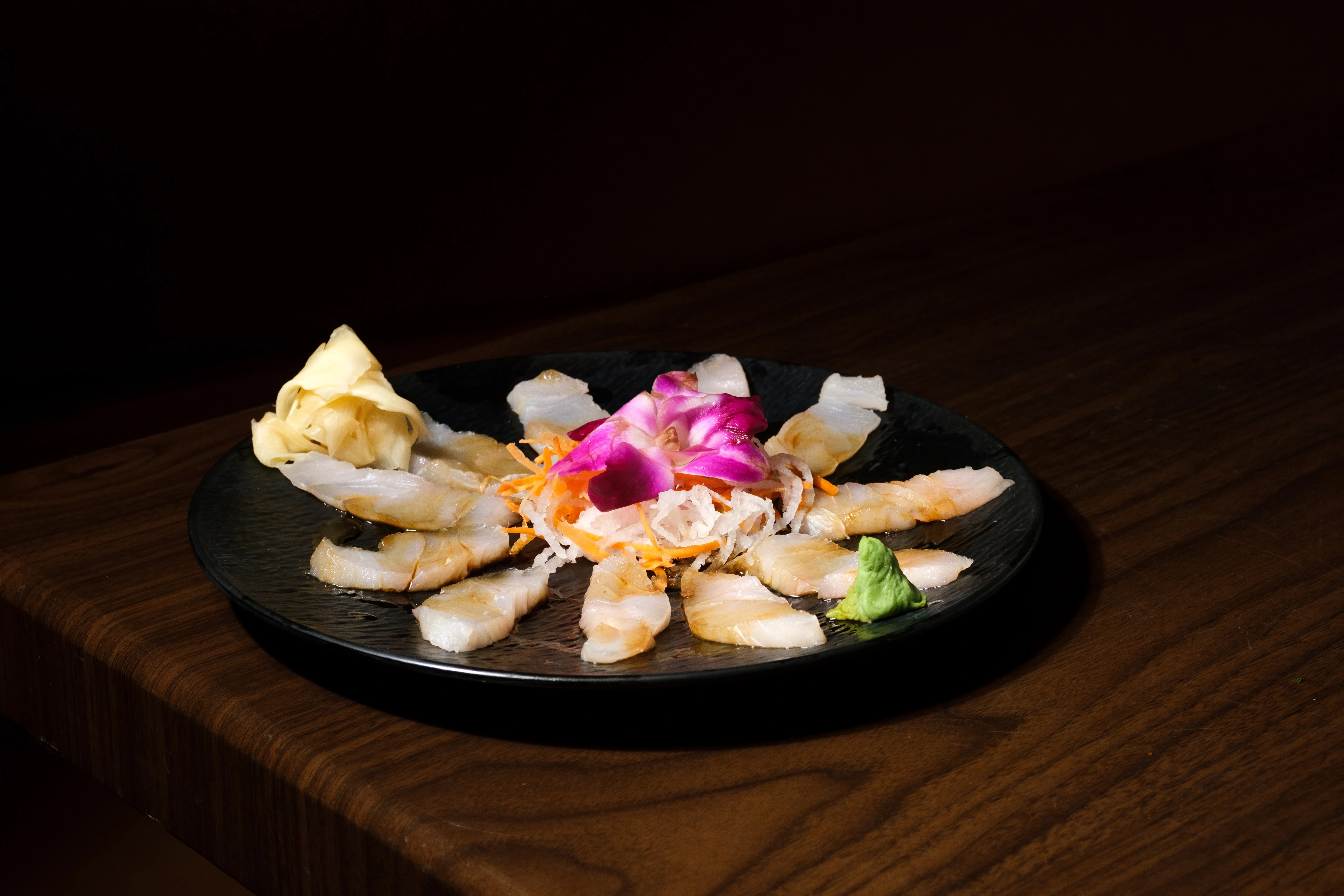 Japanese sushi platter with fresh sashimi and garnishes